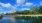 a body of water with trees and buildings in the background