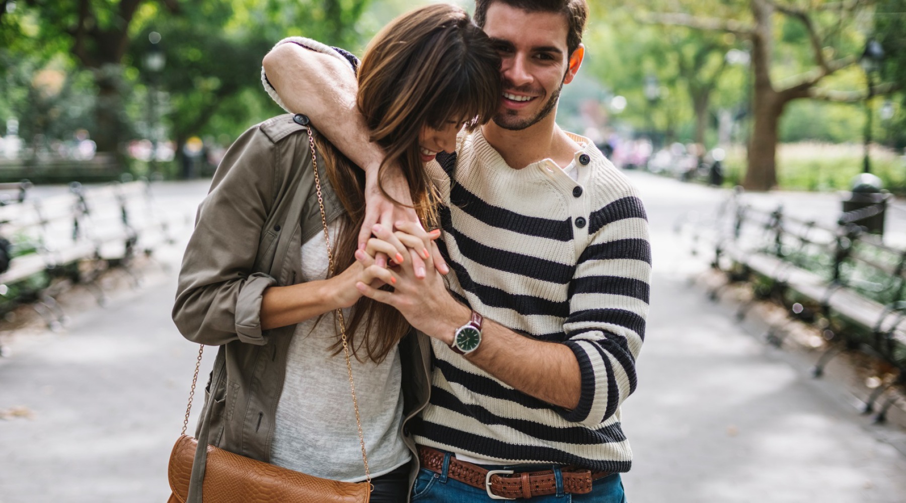 a couple walking through a park
