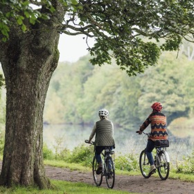 Elegance everywhere you look two people biking near lake