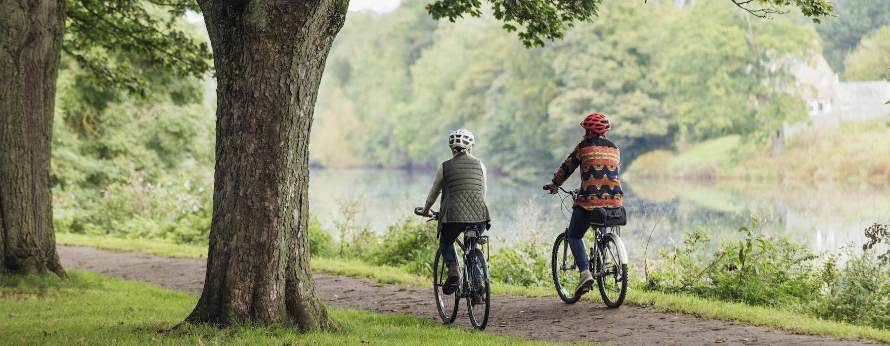 two people biking near lake